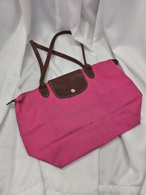 Authentic Longchamp Le Pliage tote in bright pink nylon with brown leather trim